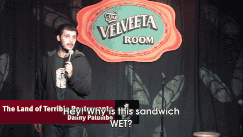 a man is giving a speech in front of a sign that says the velveta room
