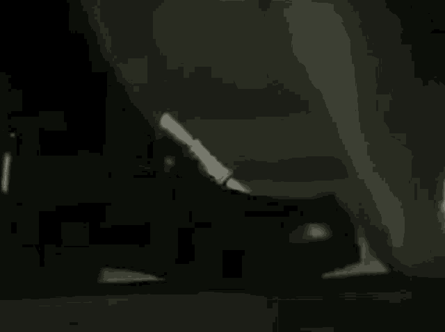 a black and white photo of a person 's butt in a dark room .