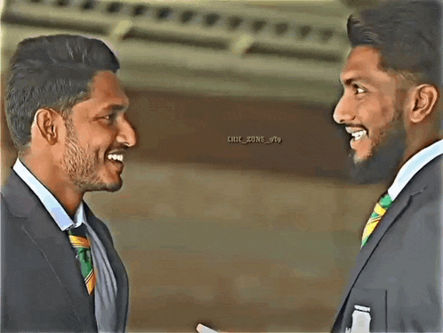 two men in suits and ties are smiling at each other and the words chic zone are on the bottom right