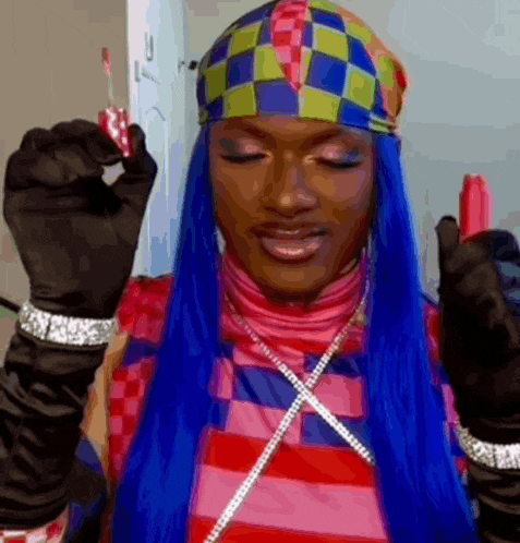 a woman with blue hair is wearing a headband and holding a lollipop