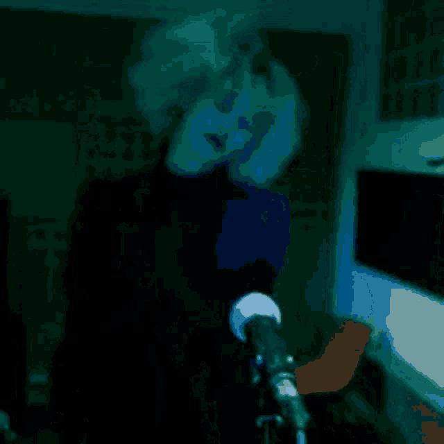 a blurry picture of a person standing in a dark room
