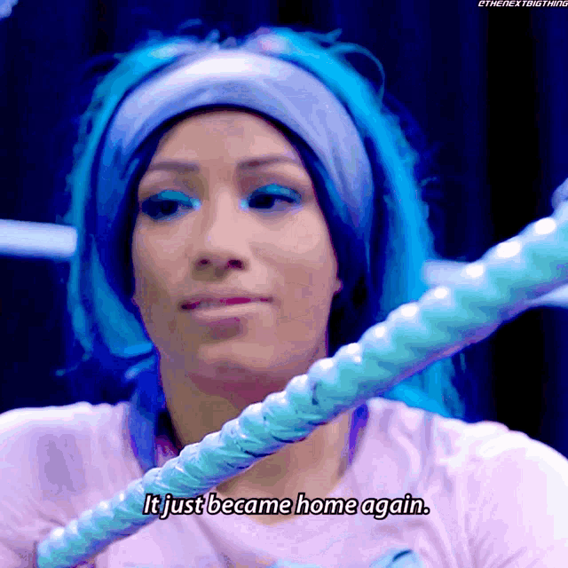 a woman with blue hair is holding a rope and says " it just became home again "