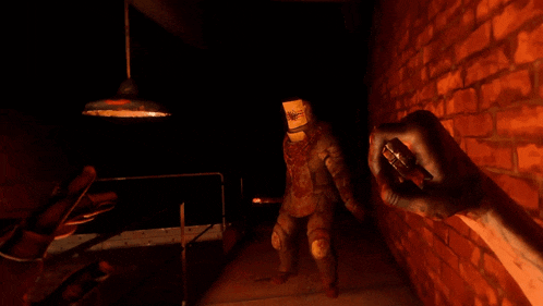 a man with a paper bag on his head is in a dark room