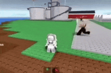 a man is walking down a sidewalk in a video game while a robot is standing in the grass .