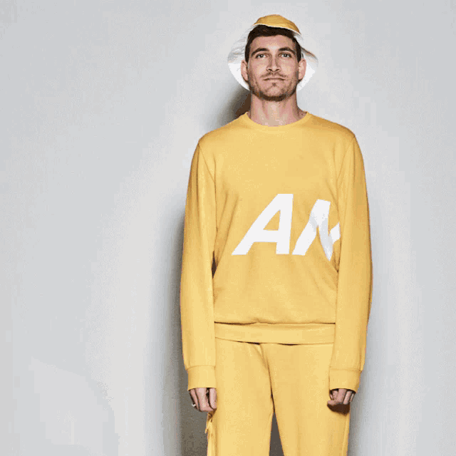 a man and a woman wearing yellow sweatshirts with an on the front