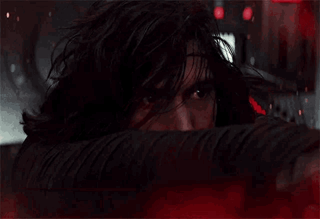 a close up of a man 's face with a red light coming out of his mouth .