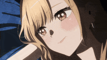 a close up of a blonde anime girl laying on a blue blanket
