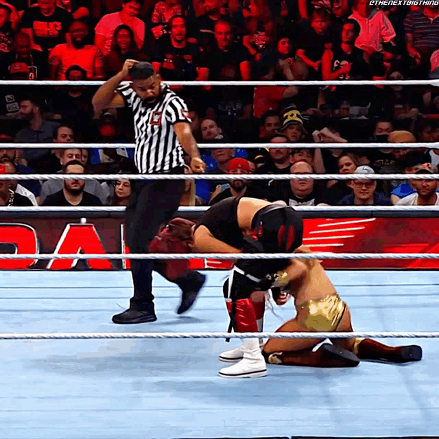 a referee in a wrestling ring with the next thing written on the bottom