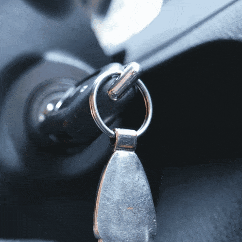 a close up of a car key with a keychain attached to it