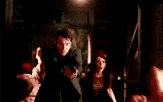 a man and a woman are standing next to each other in a room .