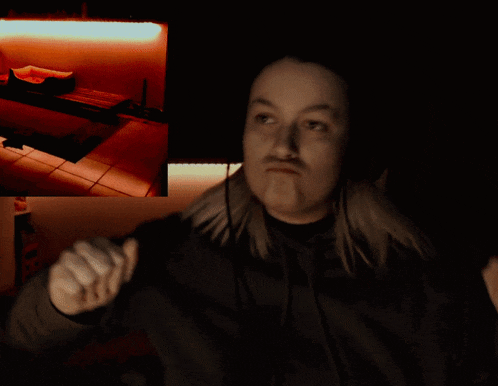 a woman wearing headphones is making a face in the dark