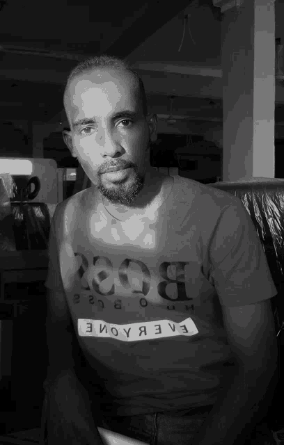a man with a beard wears a t-shirt that says boss on it