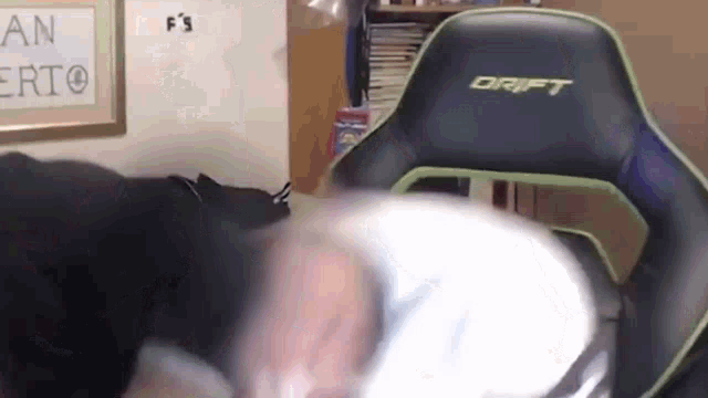 a person is sitting in a drift chair in a room .