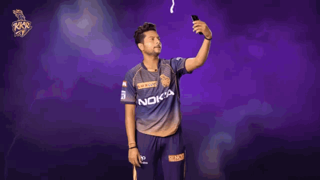 a man taking a selfie with a nokia shirt on
