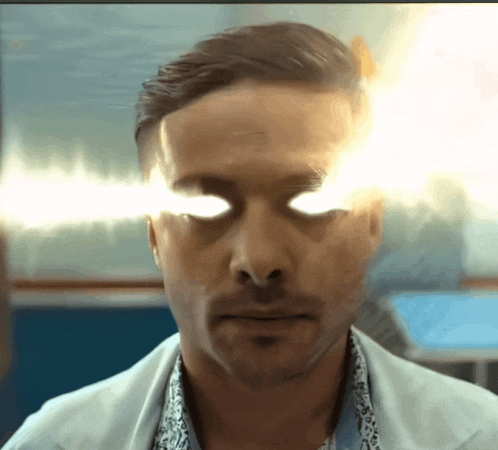 a close up of a man 's eyes with light coming out of them