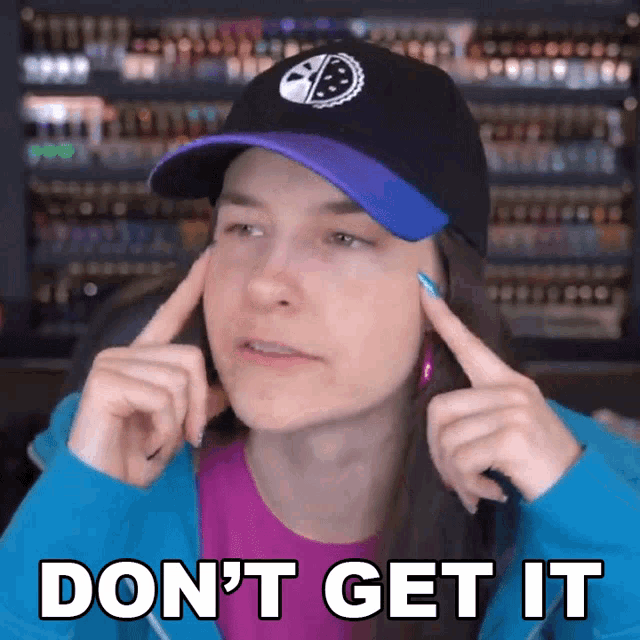 a woman wearing a purple shirt and a black hat says don 't get it