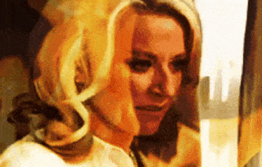 a close up of a woman 's face with a yellow background