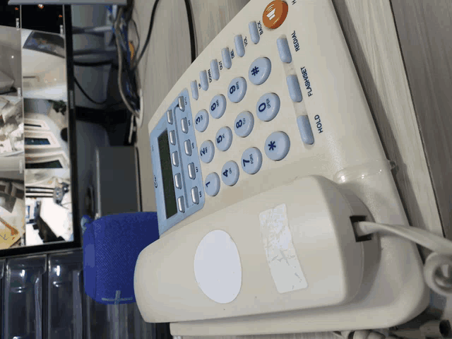 a telephone with a sticker on it that says hold