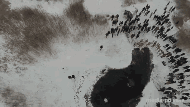 an aerial view of a group of people walking in the snow with the words media-polesye below them