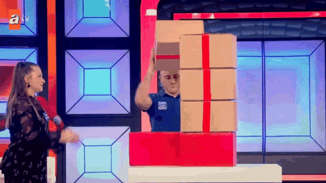 a man wearing a blue shirt that says ' atv ' on it