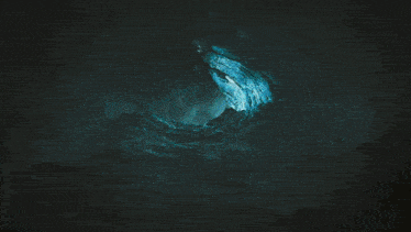 a close up of a dragon 's tail with a light coming out of it
