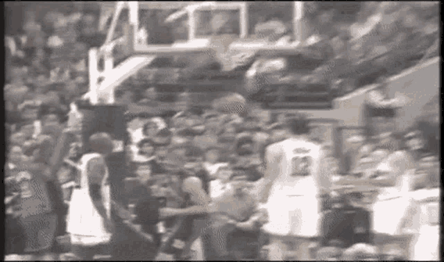 a basketball game is being played in front of a crowd with a player wearing a number 22 jersey .