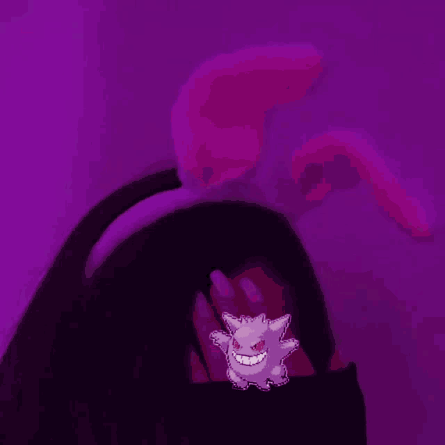 a girl wearing a headband with bunny ears and a gengar sticker