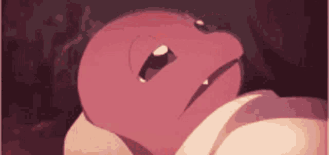 a pink cartoon character is laying on a bed with its mouth open .