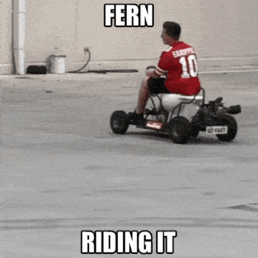 a man in a red shirt is riding a fern riding it