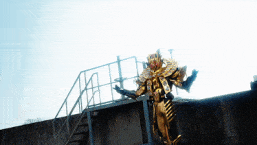 a statue of a monster is standing on top of a building