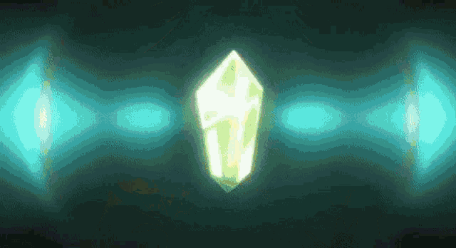a green crystal is glowing in the dark with blue lights behind it .