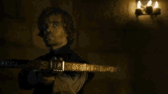 a man holding a sword in front of a black cat with white eyes