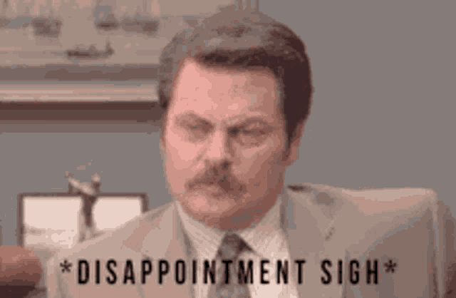 a man in a suit and tie is disappointed