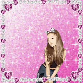 a girl wearing cat ears is standing in front of a pink background with hearts and diamonds .