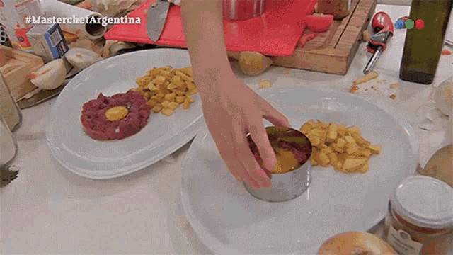 a person is preparing food on a plate with the hashtag #masterchefargentina on the bottom