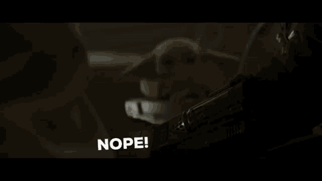 a close up of a person wearing a helmet with the words nope written on it .