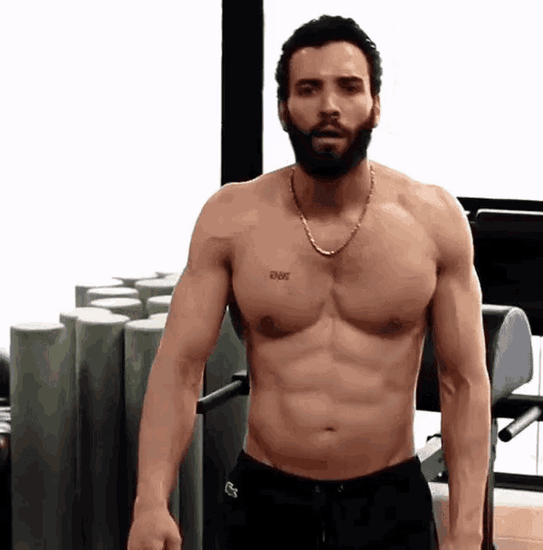 a shirtless man with a beard has a tattoo on his chest that says " ever "