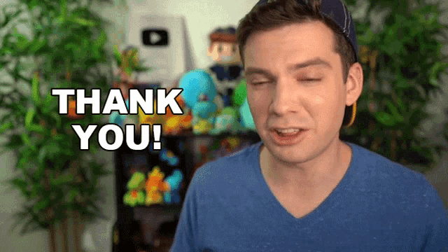 a man in a blue shirt says thank you with his eyes closed