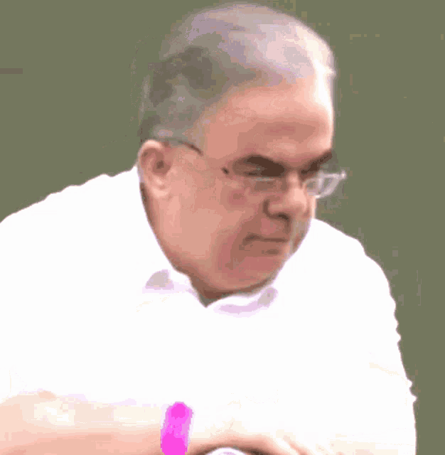 a man wearing glasses and a watch has a pink band around his wrist that says ' swatch ' on it