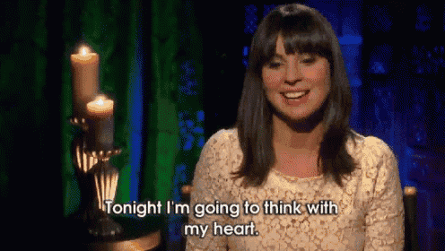 a woman is sitting in front of candles and says tonight i 'm going to think with my heart