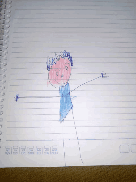 a child 's drawing of a boy in a blue shirt is on a notebook that says dom