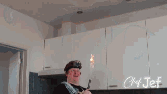 chef jef is shown in a kitchen holding a flamethrower