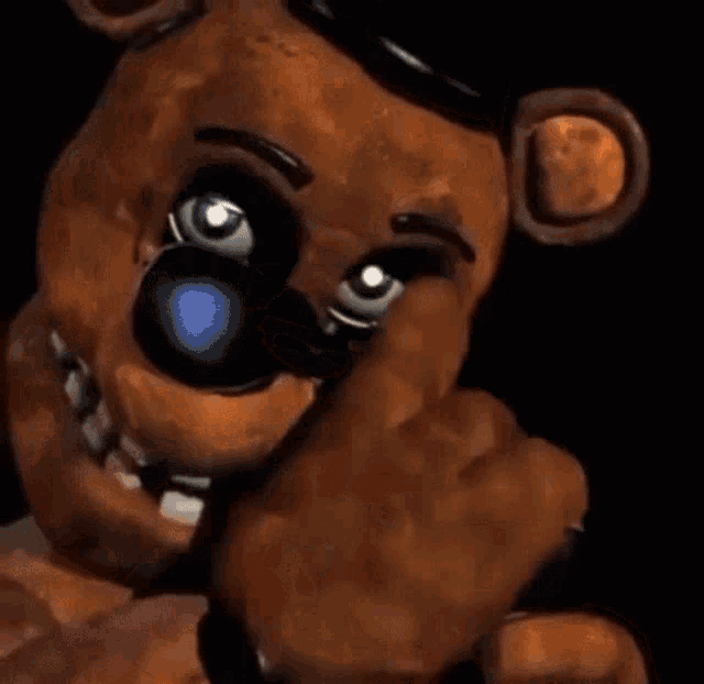 a brown teddy bear wearing sunglasses and a top hat .