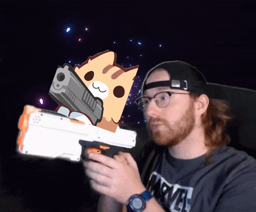 a man wearing a marvel shirt holds a toy gun