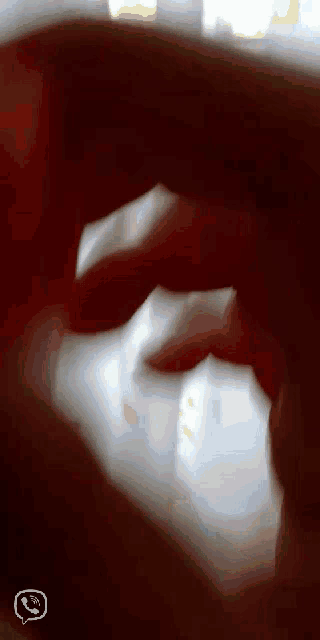 a close up of a person 's hand with a phone icon in the lower right corner