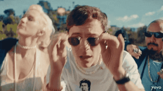 a group of people wearing sunglasses and a shirt that says vevo on it