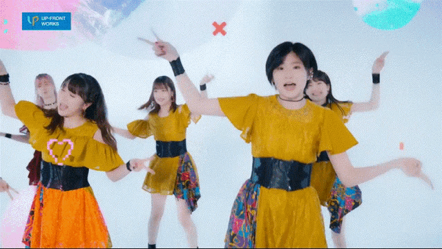 a group of young girls are dancing in front of a sign that says up front works