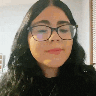 a close up of a woman wearing glasses making a face .