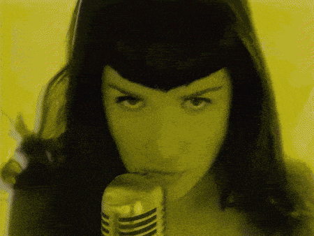 a close up of a woman 's face with a yellow background