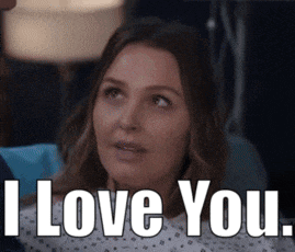 a woman is sitting in a hospital bed and says i love you
